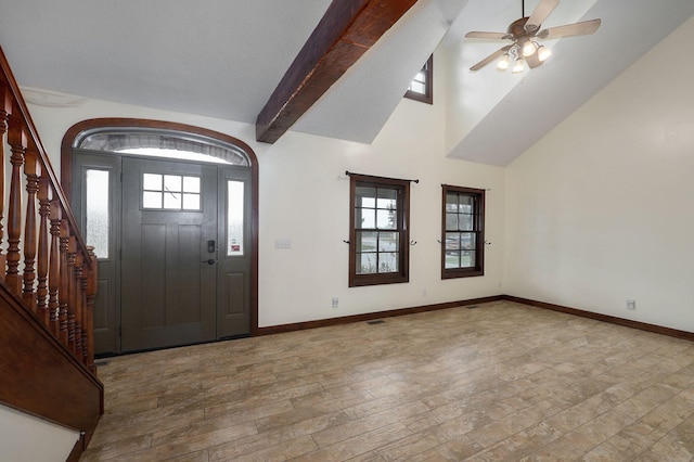 foyer entrance with high vaulted ceiling, wood finished floors, a ceiling fan, baseboards, and stairway