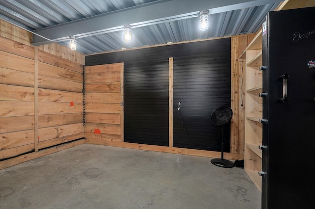 garage featuring wood walls