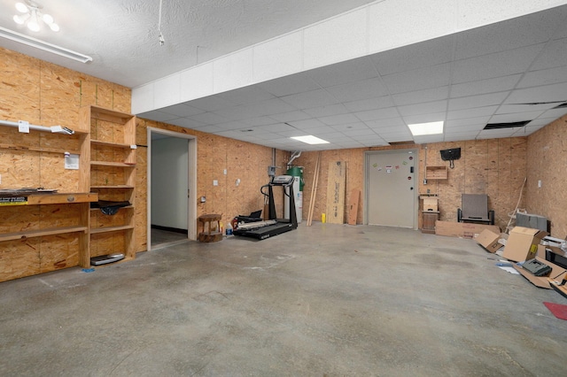 below grade area with water heater and a paneled ceiling