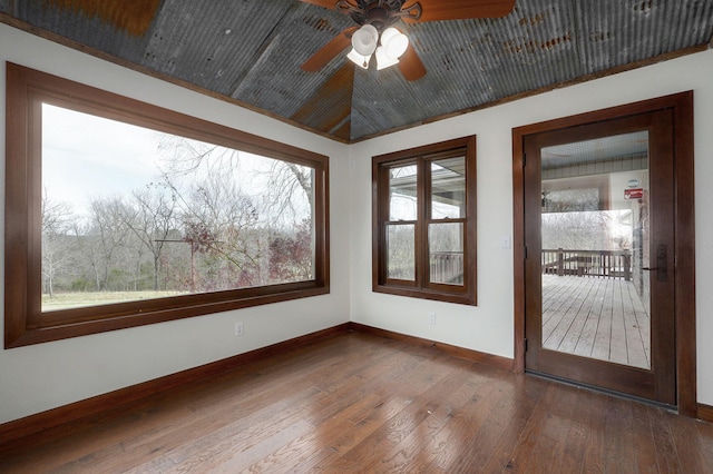 unfurnished sunroom with vaulted ceiling and ceiling fan