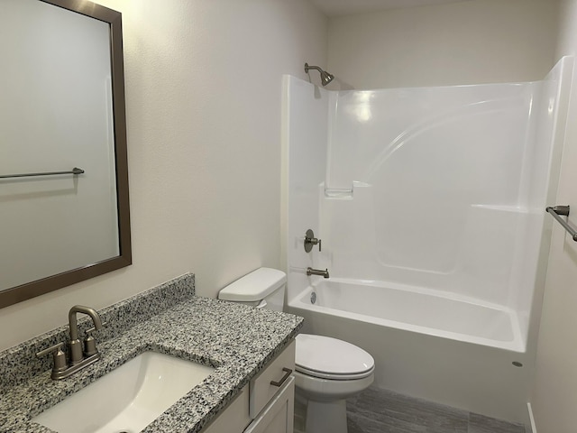 full bathroom with vanity, toilet, and  shower combination