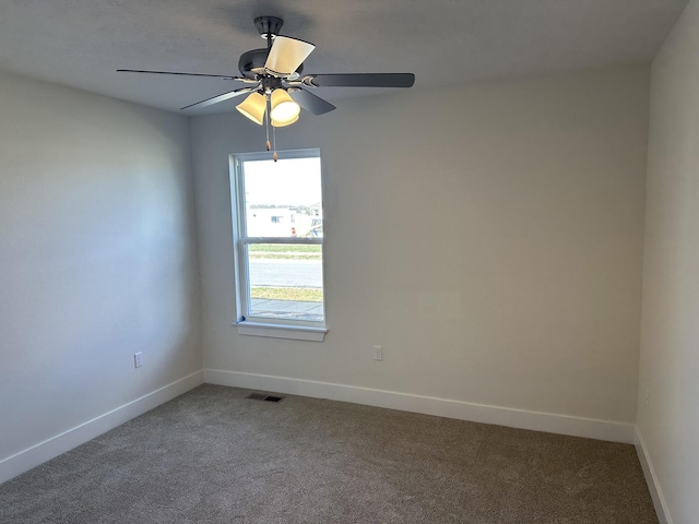 spare room featuring carpet flooring and ceiling fan