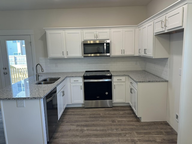 kitchen featuring kitchen peninsula, stainless steel appliances, white cabinetry, and sink