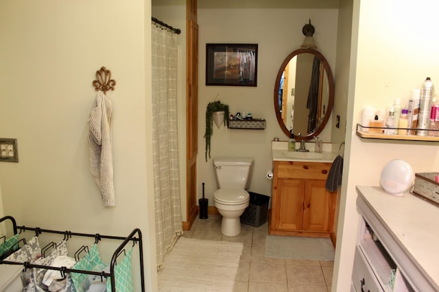 bathroom with tile patterned flooring, vanity, and toilet