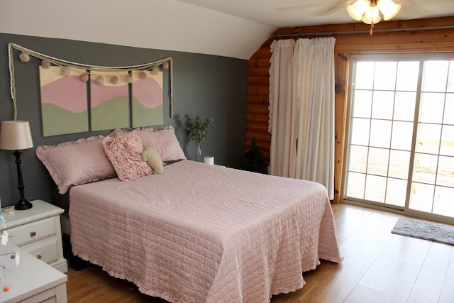 bedroom with ceiling fan, wood-type flooring, and lofted ceiling