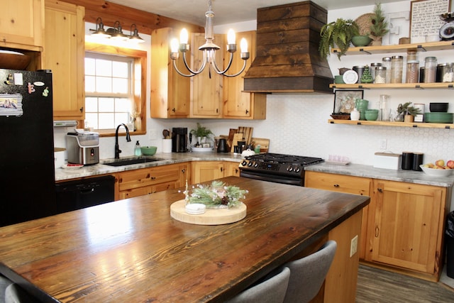 kitchen featuring black appliances, butcher block counters, sink, and premium range hood