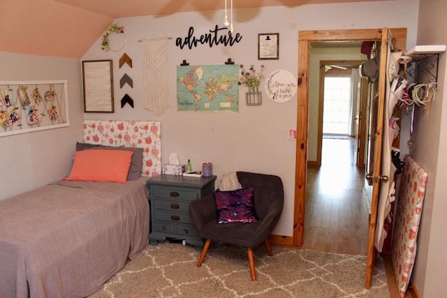 bedroom featuring wood-type flooring and vaulted ceiling