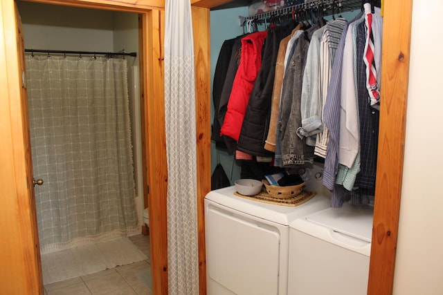 laundry room with tile patterned floors and washer and clothes dryer