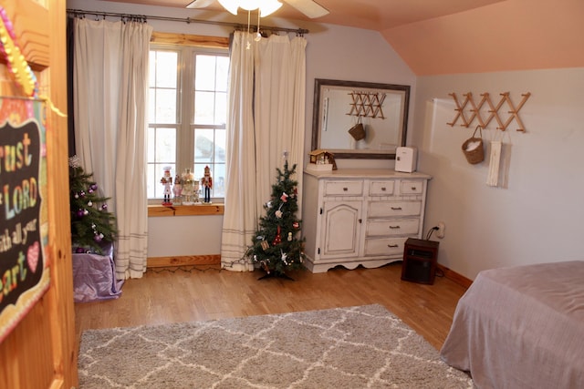 bedroom with light hardwood / wood-style flooring, ceiling fan, and lofted ceiling