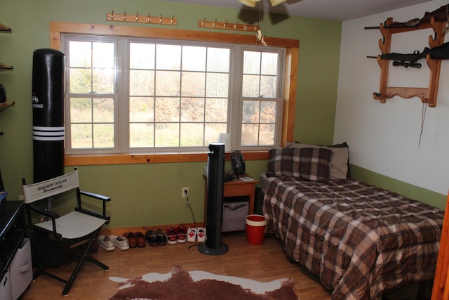 bedroom featuring multiple windows and hardwood / wood-style floors