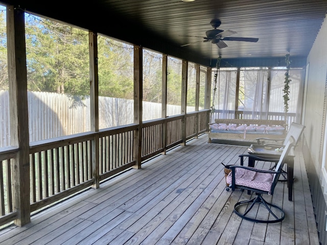 unfurnished sunroom with plenty of natural light and ceiling fan