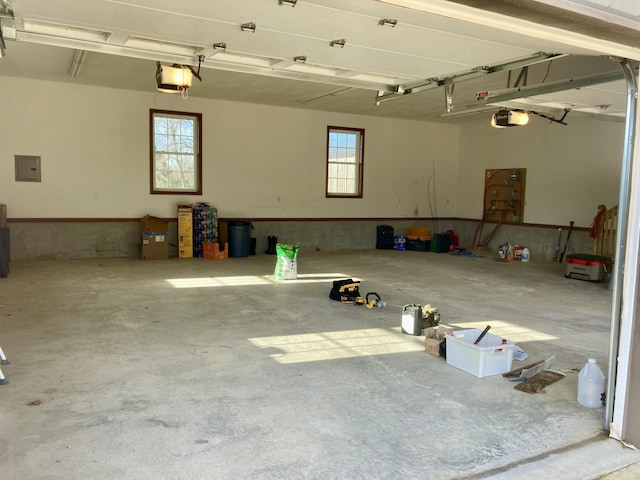 garage featuring electric panel and a garage door opener