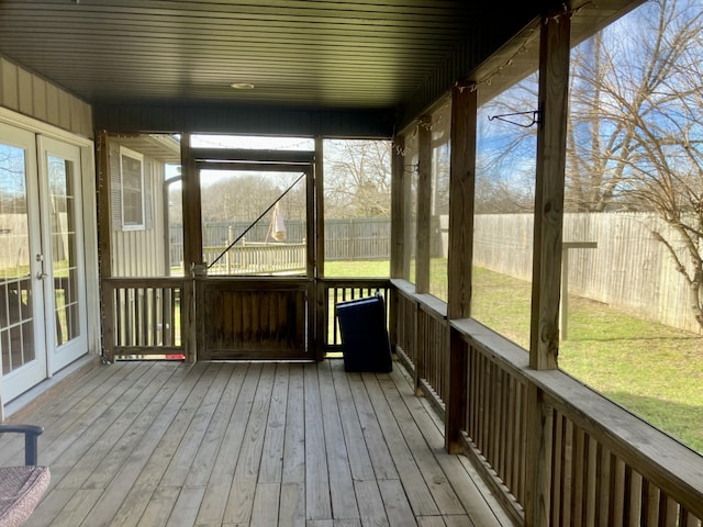 unfurnished sunroom with wood ceiling and a healthy amount of sunlight