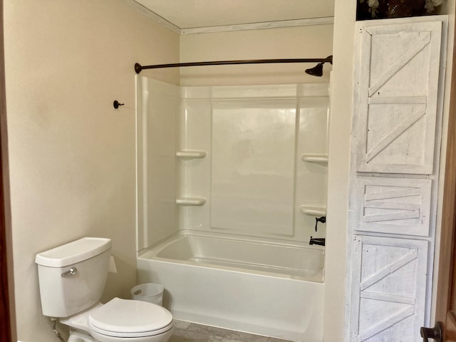 bathroom featuring shower / tub combination and toilet