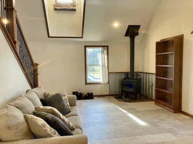 living room featuring a wood stove and vaulted ceiling