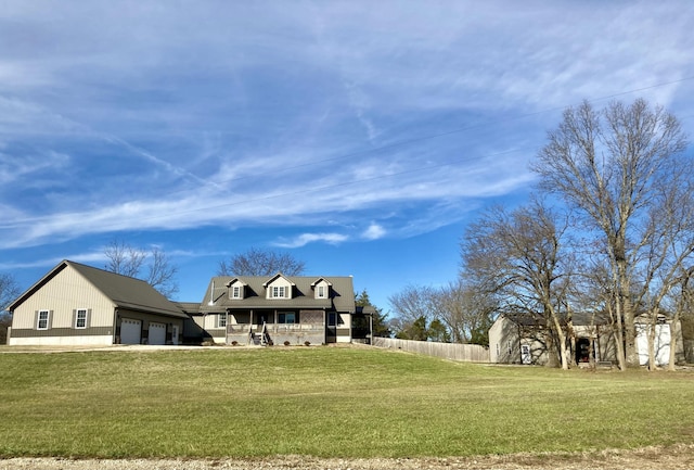 back of property with a lawn, covered porch, and a garage