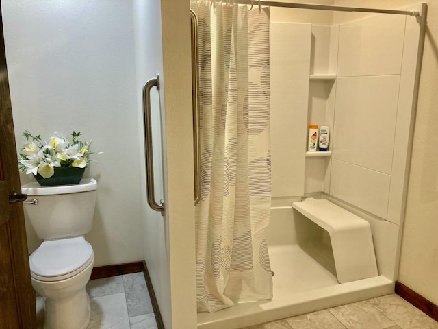 bathroom with a shower with curtain and toilet