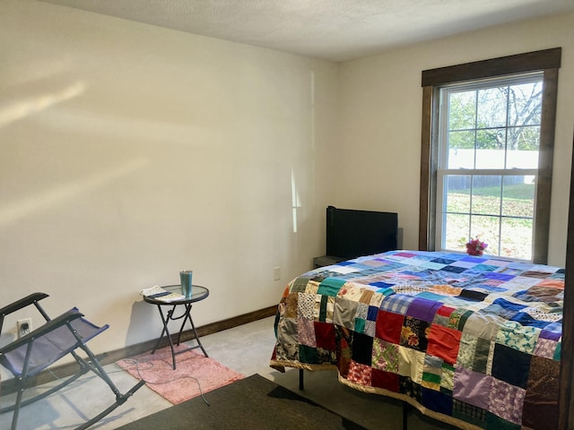 carpeted bedroom featuring a textured ceiling