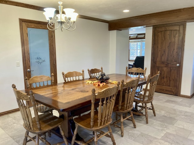 dining area with a chandelier and crown molding