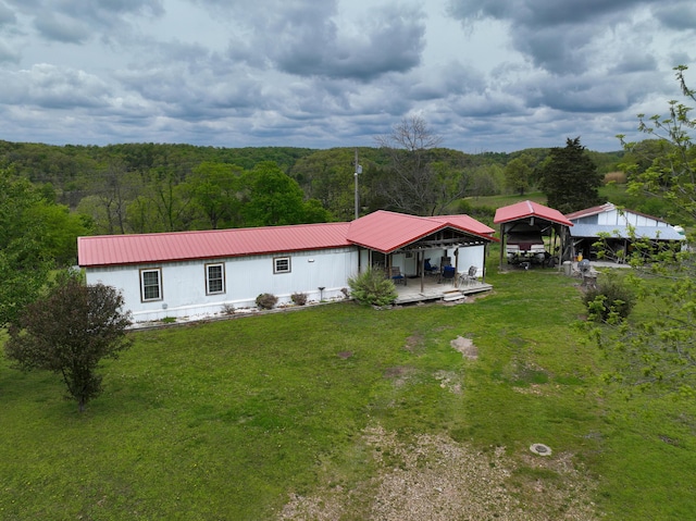 back of house with a lawn and a deck