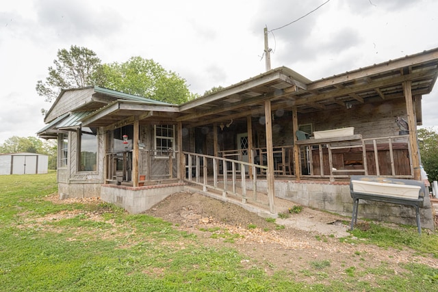 rear view of house featuring a storage unit