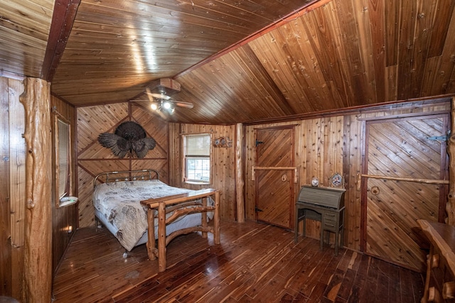 bedroom with wooden walls, hardwood / wood-style floors, wooden ceiling, and vaulted ceiling