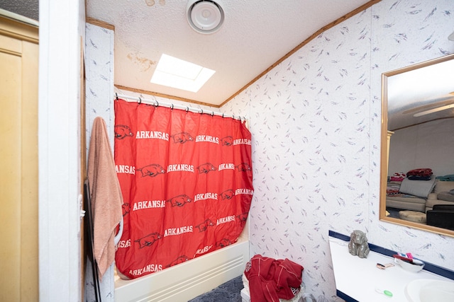 bathroom with crown molding, a textured ceiling, shower / tub combo with curtain, vanity, and vaulted ceiling with skylight