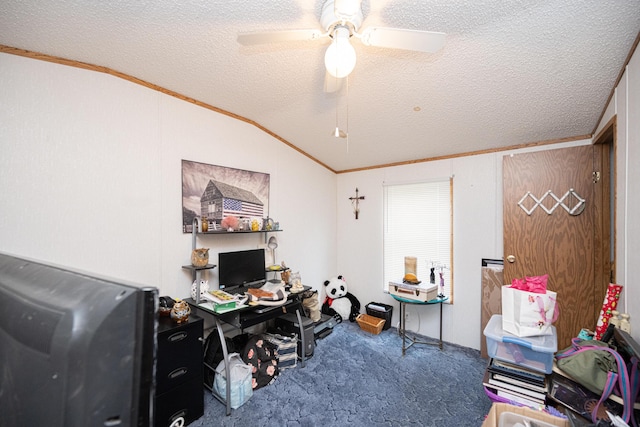 home office featuring a textured ceiling, carpet floors, vaulted ceiling, and ceiling fan