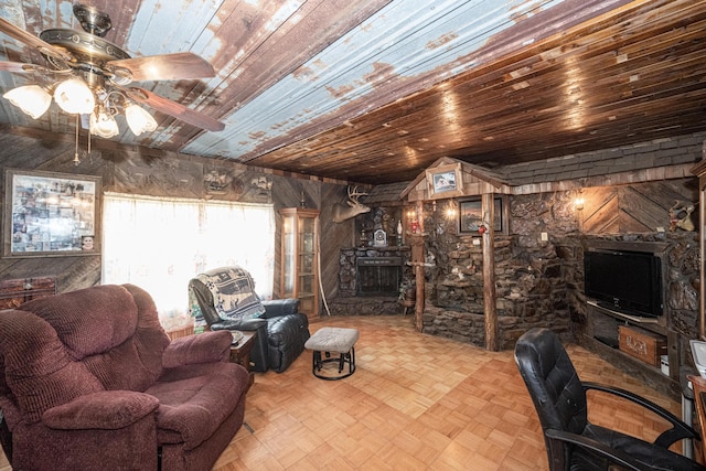 interior space with a fireplace, light parquet floors, ceiling fan, and wooden ceiling