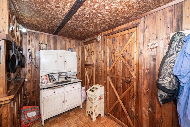 misc room with wood walls and light parquet floors