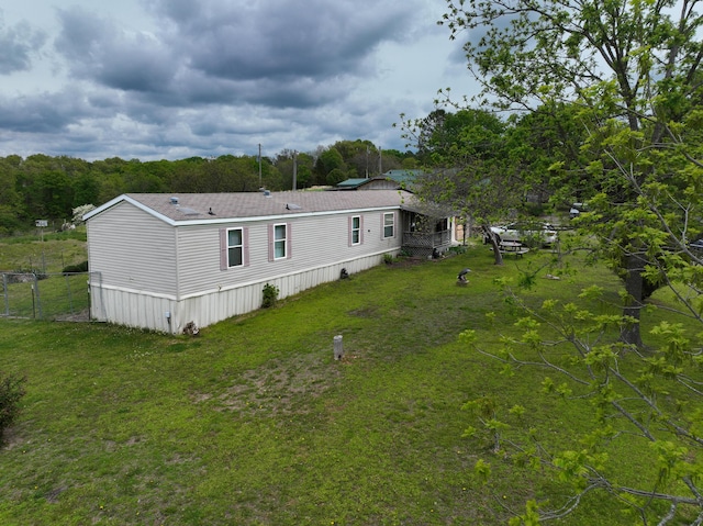 rear view of property featuring a lawn