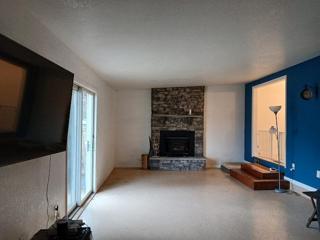 unfurnished living room with a stone fireplace and a textured ceiling