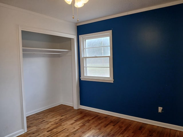 unfurnished bedroom with a closet and wood-type flooring