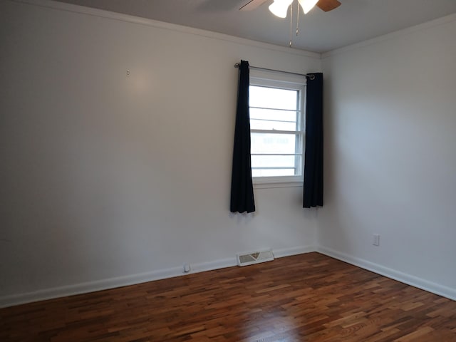 empty room with dark hardwood / wood-style flooring, ceiling fan, and ornamental molding