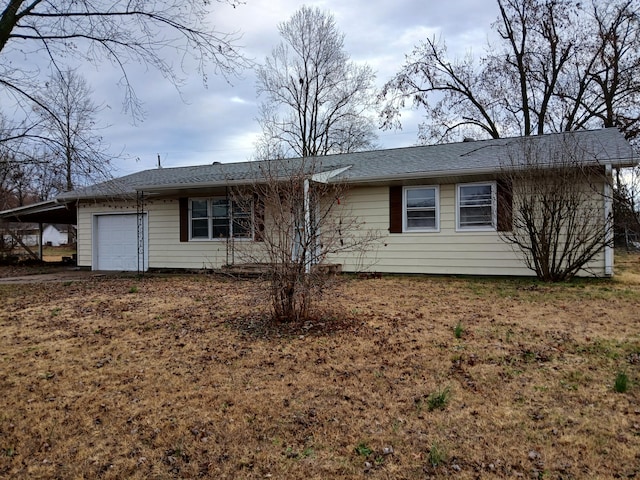 ranch-style house featuring a garage and a carport