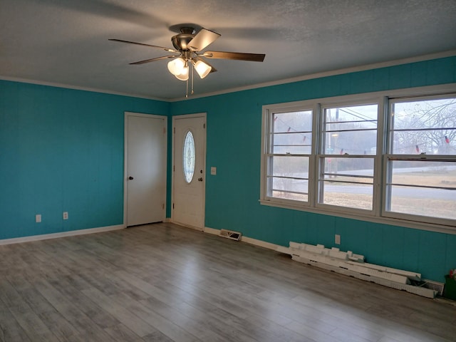 spare room featuring ceiling fan, crown molding, a textured ceiling, and hardwood / wood-style flooring