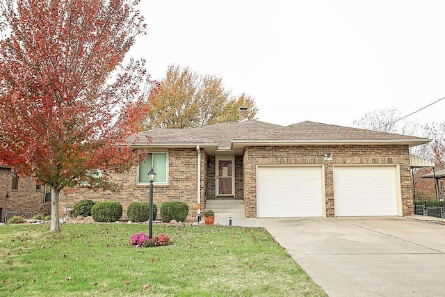 view of front of home with a garage and a front lawn