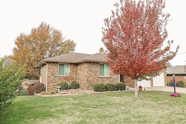 view of front of house with a garage and a front lawn