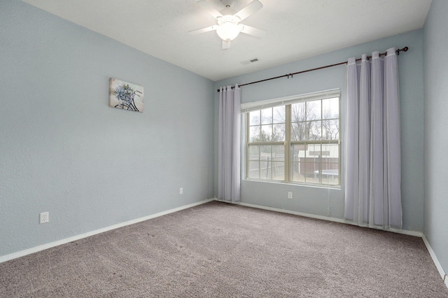 carpeted empty room featuring ceiling fan