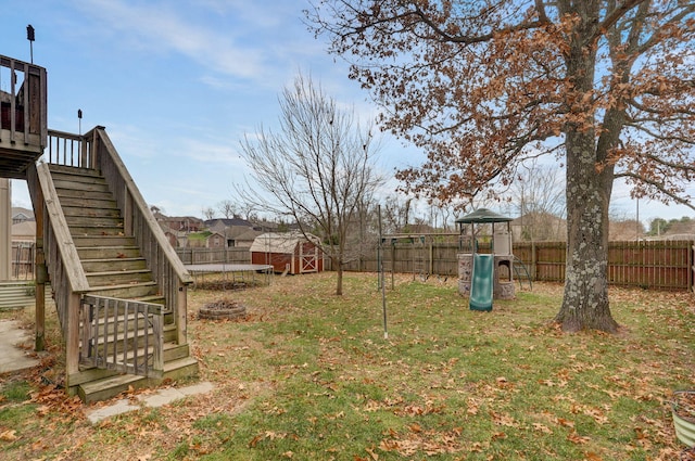 view of yard featuring a trampoline and a playground