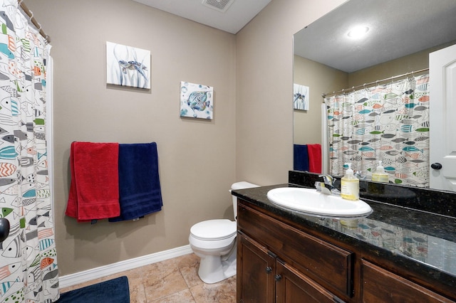 bathroom featuring tile patterned floors, vanity, and toilet