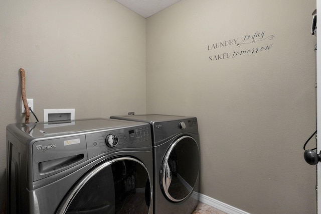 clothes washing area with separate washer and dryer