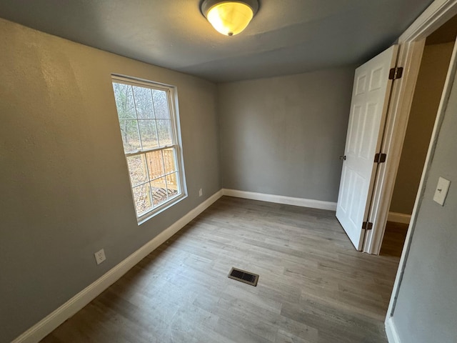 unfurnished room with light hardwood / wood-style floors