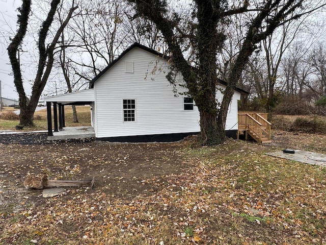 view of side of home with a carport