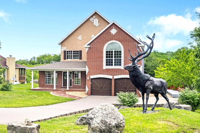 view of front of property featuring a front yard and a garage