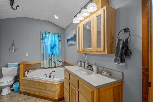 bathroom featuring vanity, a tub to relax in, a textured ceiling, and vaulted ceiling