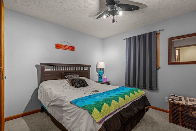 carpeted bedroom with a textured ceiling and ceiling fan