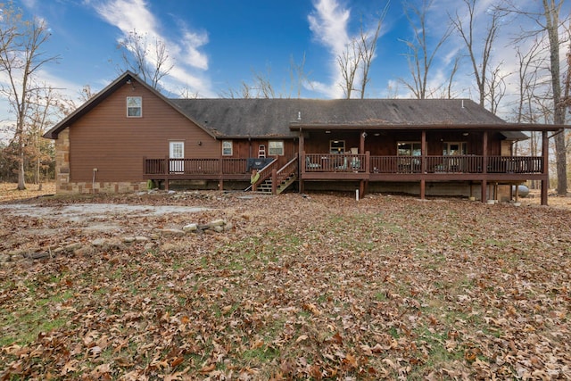 rear view of property featuring a deck