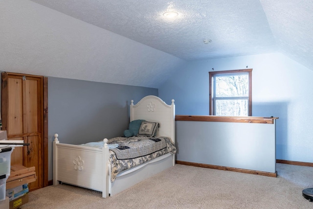 bedroom with light colored carpet, a textured ceiling, and vaulted ceiling