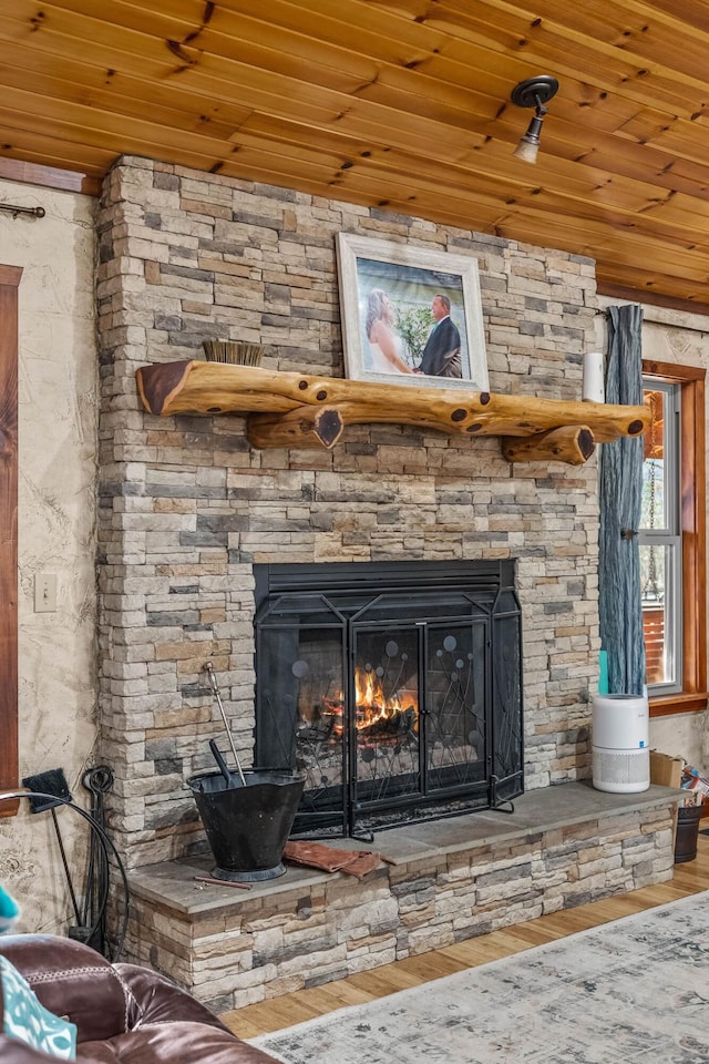 details with a fireplace, wooden ceiling, and hardwood / wood-style flooring